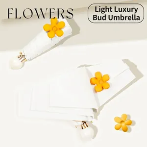 Compact portable white flower-themed sun and rain umbrella with UV protection layer