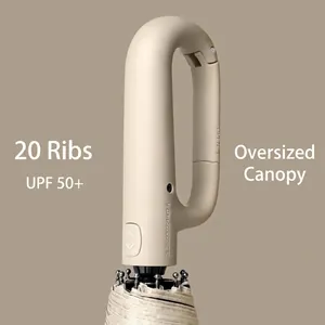 Beige automatic folding umbrella with caribiner hook handle and 20 reinforced ribs.