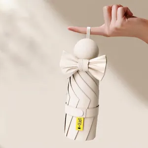 Compact off-white capsule sun umbrella with bow, UPF 50+ UV protection parasol