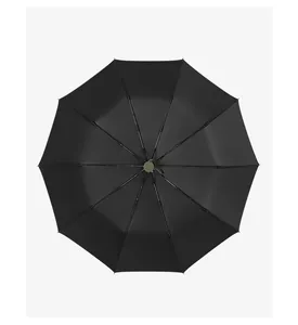 Top-down view of a large black windproof automatic umbrella canopy in a clean studio setting