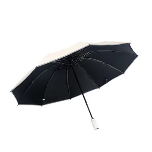 Large automatic folding umbrella with beige exterior and black UV coating for sun protection