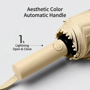Beige automatic folding umbrella handle with 1-second quick release button detail