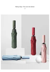 Automatic folding umbrellas in green, red, pink, and blue shown on minimalist props