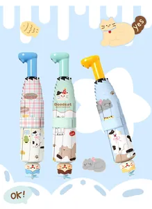 Detail of three cute cat-themed folding umbrellas with decorative windmill attachments