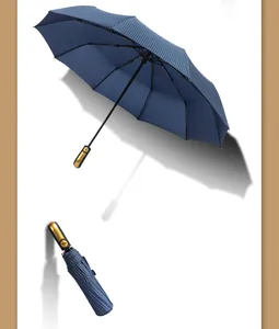 Detailed view of large navy pinstripe automatic folding umbrella showing open and closed states