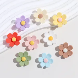 Close-up of colorful matte resin six-petal flower charms for DIY jewelry and crafts
