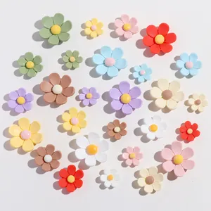 Close-up of colorful resin flower accessories for DIY hair clips and fridge magnets