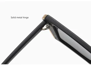Detailed macro shot showing the solid metal hinge of premium square frame sunglasses.
