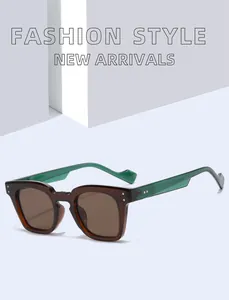 Detailed view of vintage square sunglasses with brown frames and green temples