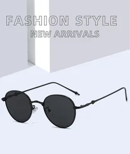 Gafas de sol retro con montura redonda de metal y lentes oscuras en un entorno minimalista