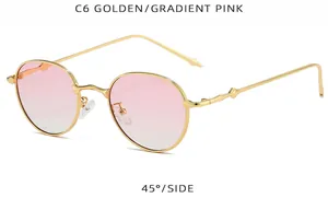 Primer plano de gafas de sol redondas doradas con lentes degradadas rosa