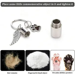 Close-up of stainless steel urn keychain for pet ashes with wing and paw charms