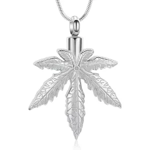 Close-up view of silver maple leaf cremation urn necklace for pet or human ashes keepsake.