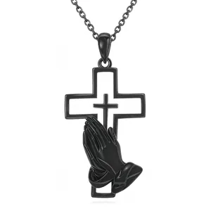 Close-up of black stainless steel cross pendant with praying hands design