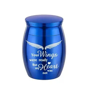Close-up of blue cremation urn with laser engraved wings and heart memorial quote detail