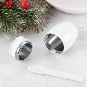 Detailed view of the open white aluminum mini pet cremation urn with matching spoon