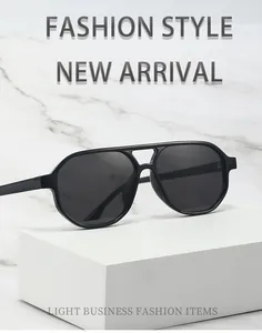Close-up detail of retro double bridge aviator sunglasses on white marble display