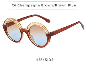 Lunettes de soleil rondes avec monture champagne et verres dégradés bleu-marron.