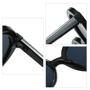 Gros plans sur les lunettes de soleil rondes noires oversize avec protection UV.