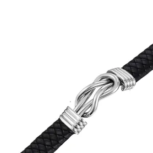 Close-up of the silver knot clasp on a black braided leather cremation bracelet.