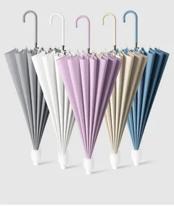 Five long-handle umbrellas in pastel colors with curved handles and white stands