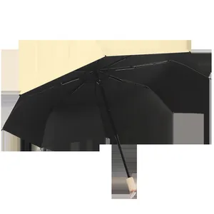 Vintage large foldable umbrella with black sun protection coating and wooden handle
