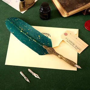 Detailed close-up of a vintage emerald quill pen with ornate bronze handle and spare nibs