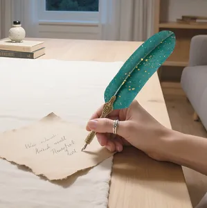 Close-up detail of a vintage dark green feather dip pen with elegant gold engraving