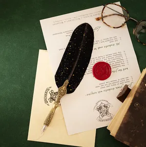Close-up of a vintage black and gold quill pen with an ornate metallic engraved handle