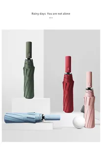 Four stylish automatic folding umbrellas in assorted colors displayed in a studio setting