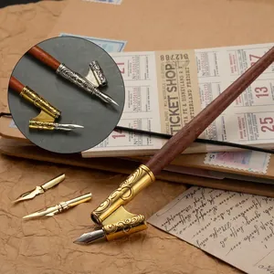 Vintage calligraphy dip pen set with ornate gold and silver nib holders for script writing.