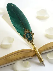 Vintage emerald green feather dip pen with ornate gold metal grip and rose motif.