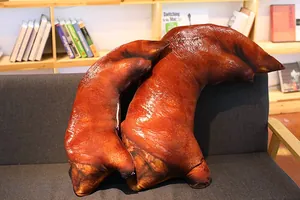 Realistic 3D printed pig trotter plush pillows on a sofa for funny home decoration