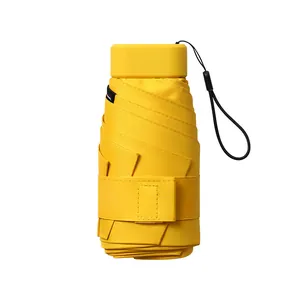 Mini portable folding sun and rain umbrella in vibrant yellow with compact 6-fold design