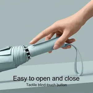 Automatic windproof folding umbrella with tactile button in mint green for rainy days