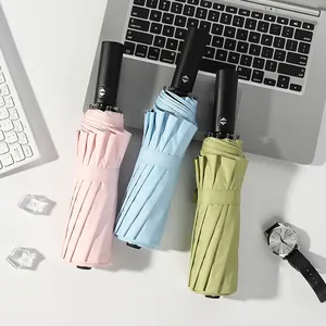 Three automatic folding umbrellas in pastel colors for sun and rain protection