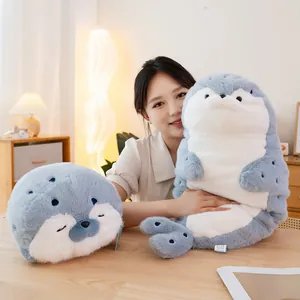 Adorable soft grey and white seal plush toy held by a girl in a cozy home setting
