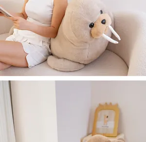 Large plush walrus stuffed toy displayed against a sofa in a cozy home lifestyle scene