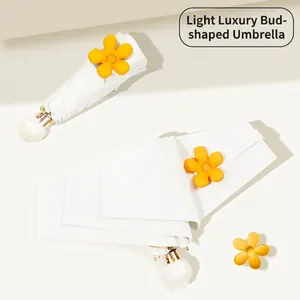 White minimalist five-fold sun umbrella with yellow flower bud and pearl handle