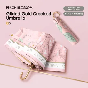 UPF50+ floral folding sun umbrella with golden curved handle and pink UV coating