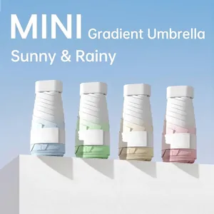 Collection of four gradient mini portable folding umbrellas for sun and rain protection