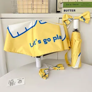 Portable cute yellow foldable sun & rain umbrella with bow tie and Let's Go Play print