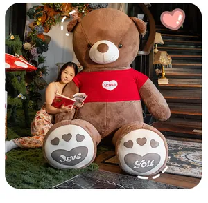 Giant brown teddy bear plush toy wearing red sweater with embroidered love messages