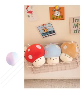Three cute colorful mushroom plush toys in a pink basket against a soft background