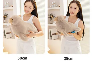 Walrus plush toy in 50cm and 35cm sizes held by a model for scale