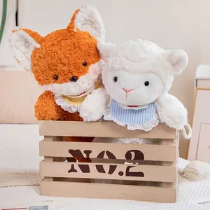 Adorable plush fox and sheep animal dolls with lace bibs in a rustic wooden crate