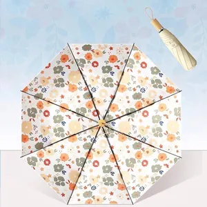 Sombrilla plegable compacta para sol y lluvia con protección UV y diseño de flores