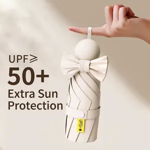 Compact capsule sun umbrella with bow tie and UPF 50+ UV protection