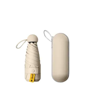 Compact UPF50+ beige capsule sun umbrella with matching portable hard storage case