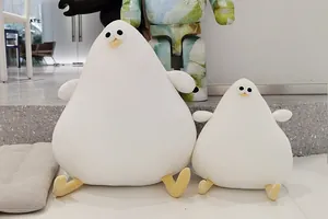 Detailed side-by-side display of two cute white pear-shaped seagull plush toys indoors.